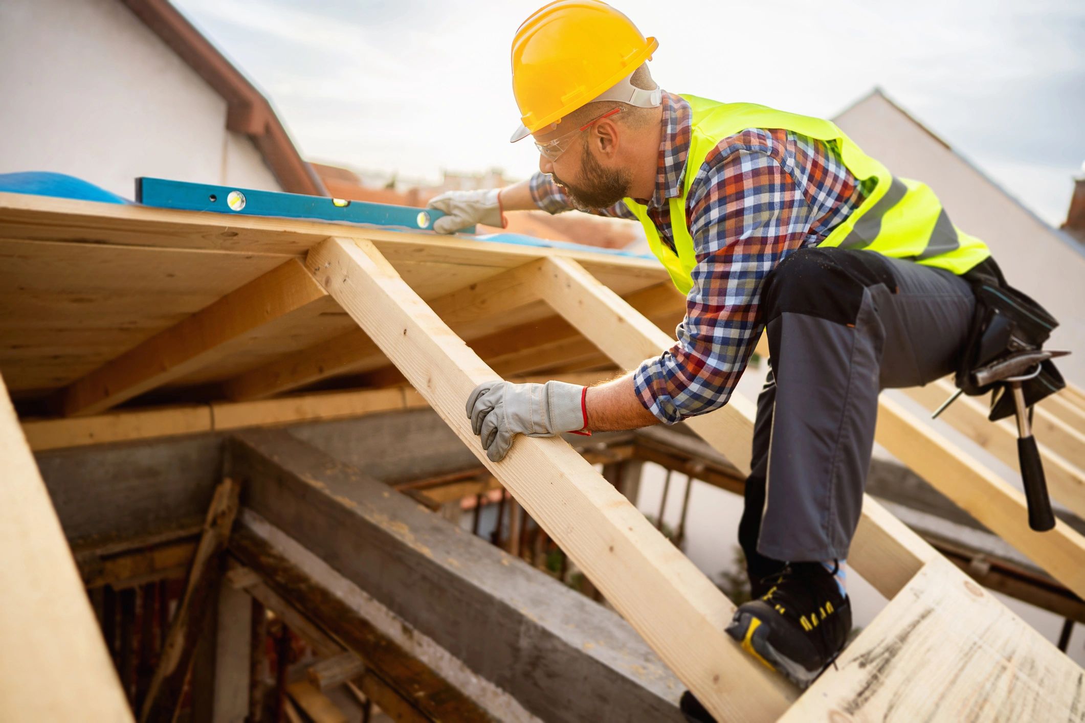 Roofing professional inspecting a residential roof for condition, drainage, and workmanship