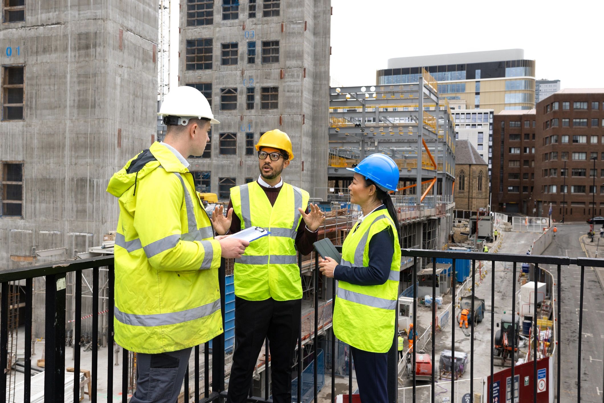 Roofing professionals reviewing plans on a job site