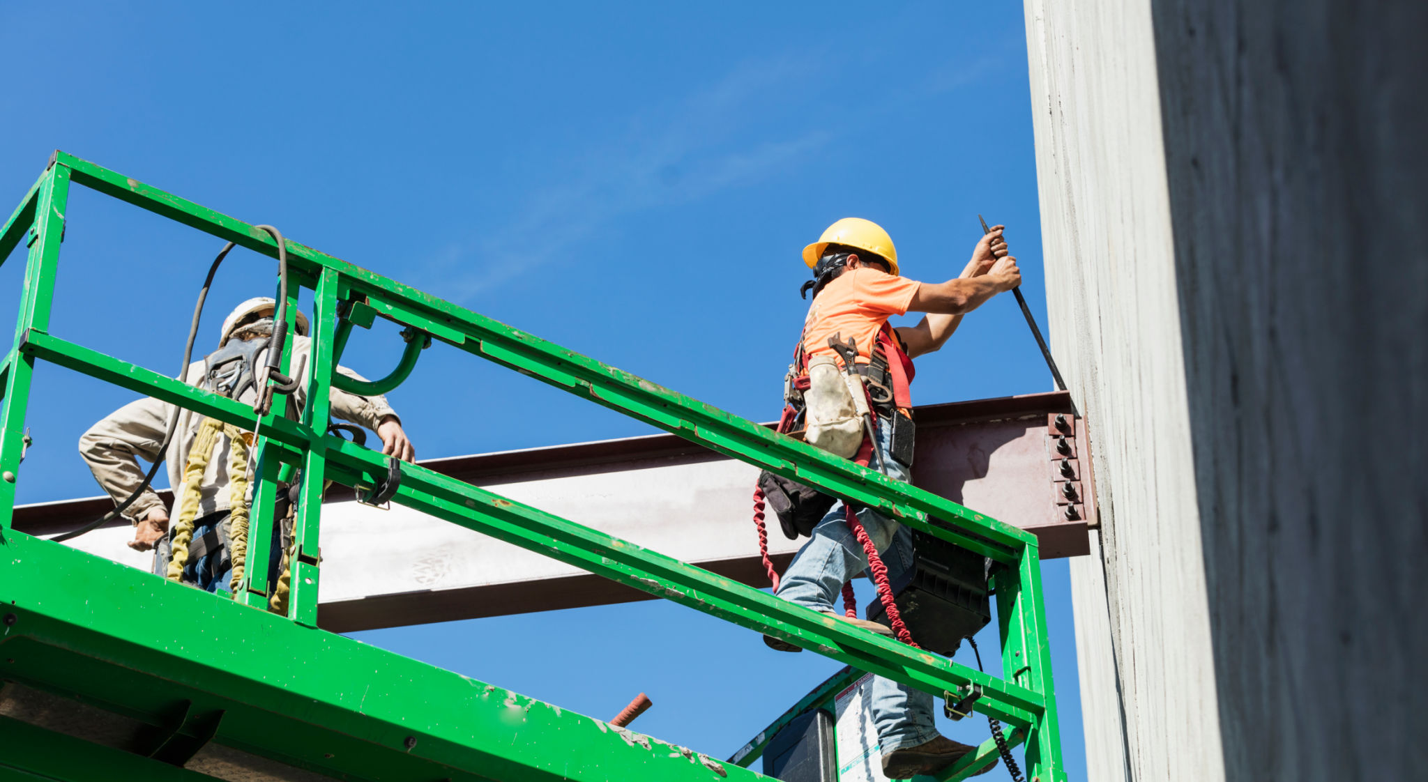 Roofing professional performing an exterior roof inspection on a home