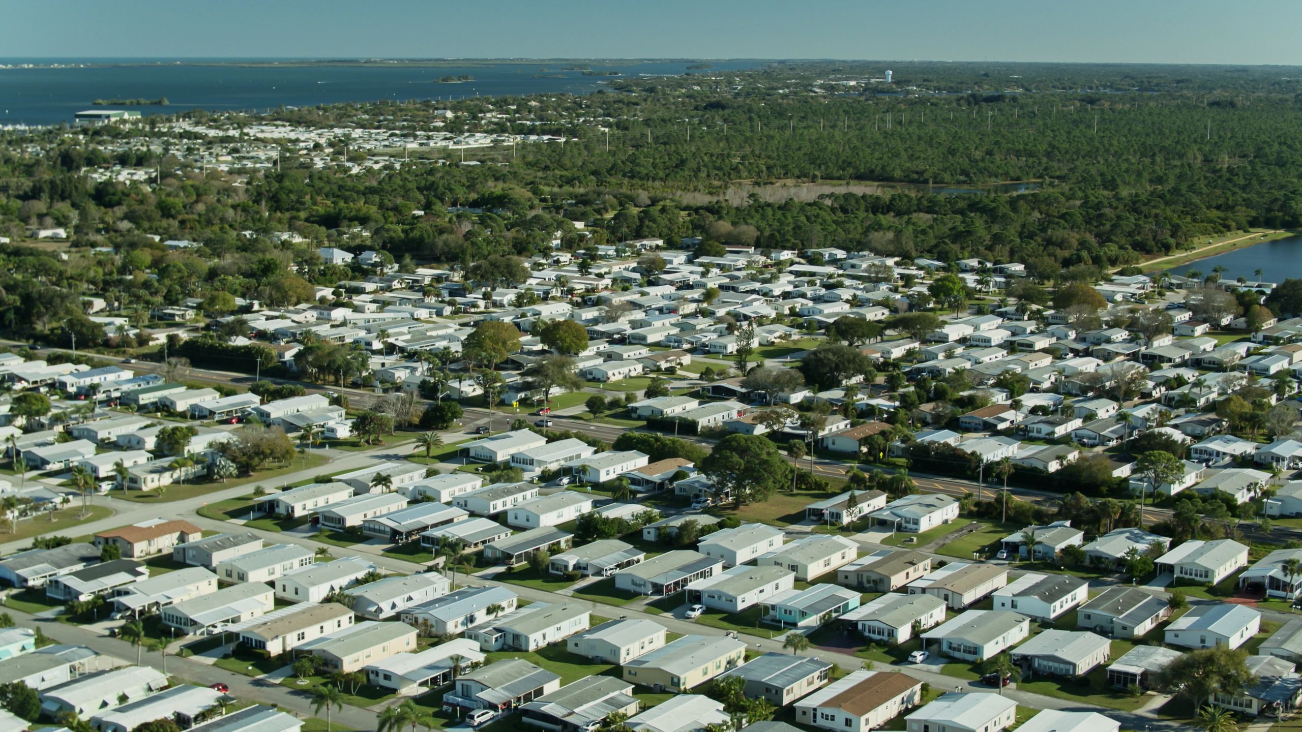Aerial view of a South Florida residential community with tile and shingle roofs